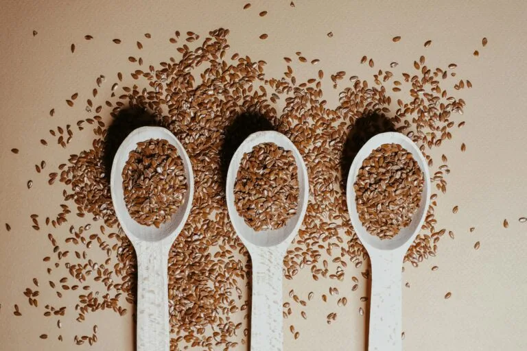 Delicious Easter Recipes with Egg Substitutes 1 | eat move healthy Easter- Recipes-Flat lay of organic flaxseeds in wooden spoons showcasing natural nutrition and texture.