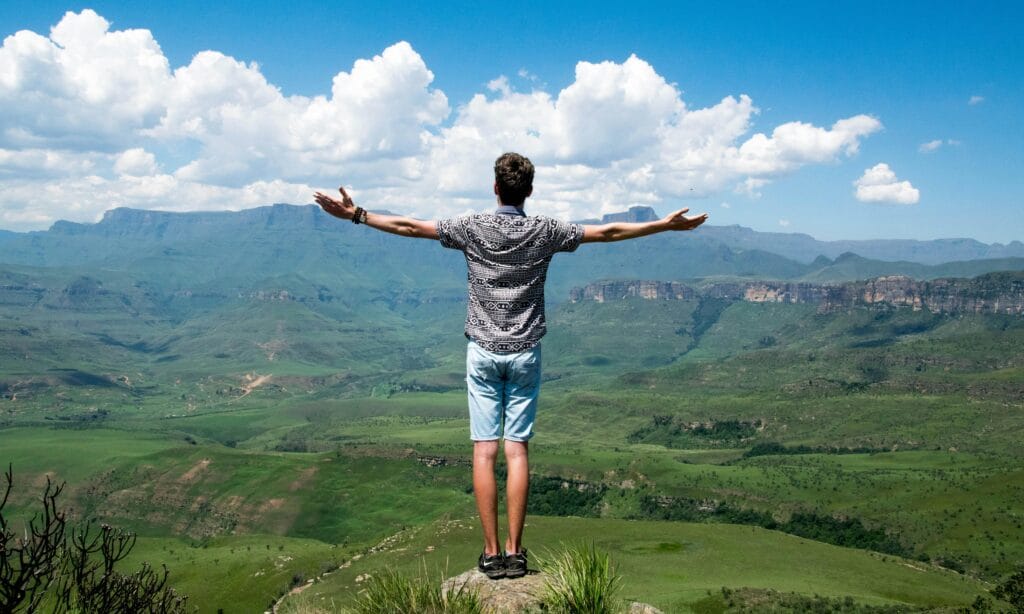 10 Surprising Health Facts You’ve Never Heard 4 | eat move healthy A man stands triumphantly with arms open, overlooking a scenic mountain range.