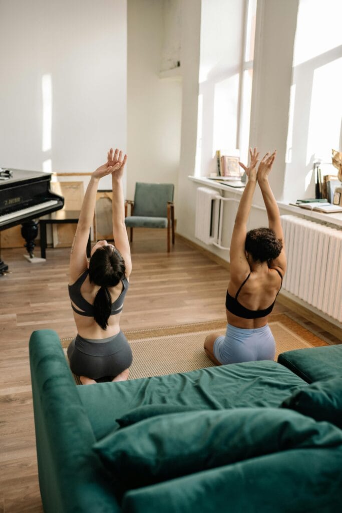 30 Day Fitness Challenge 10 | eat move healthy Two women in sportswear performing yoga in a cozy living room.