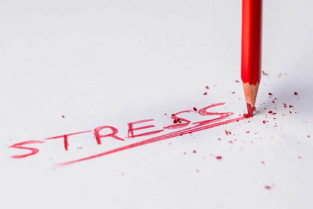 10 Surprising Health Facts You’ve Never Heard 7 | eat move healthy Close-up of a red pencil writing 'stress' on paper, symbolizing pressure and creativity.