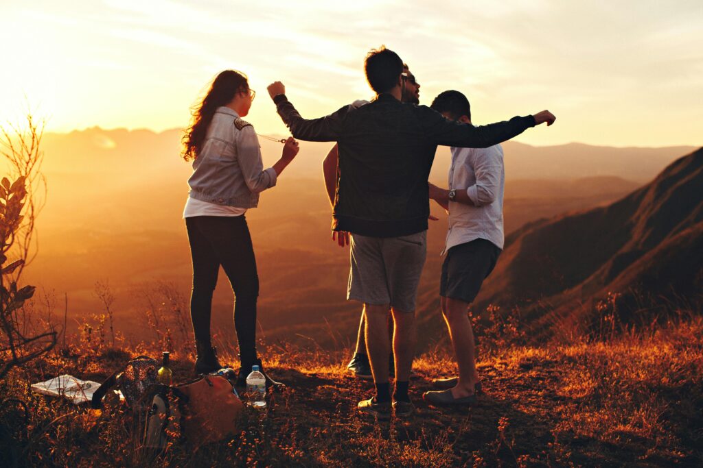 Best Tips to Stop Stress Eating 5 | eat move healthy Joyful group of young adults enjoying a sunset view in a mountainous landscape in Brazil.