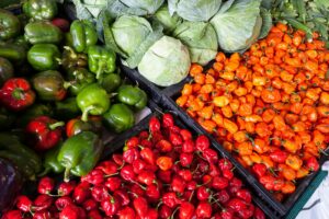5 Steps Efficient Healthy Meal Planning 3 | eat move healthy A vibrant display of fresh vegetables including peppers and cabbage at an outdoor market.
